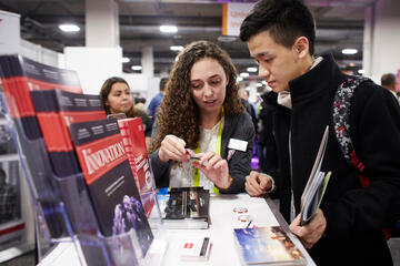 A UNLV employee talking to an attendee at CES.