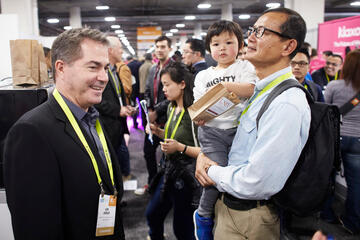 President Jessup with a crowd of people at CES convention.