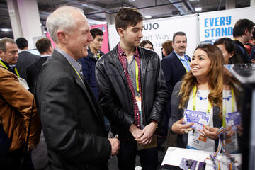 UNLV students talking to attendees at CES convention.