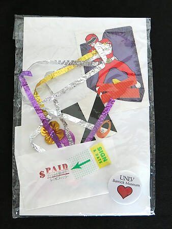 Abstract travel collage by Aurore Giguet named Power Package containing a cartoon image of a power ranger and a UNLV Barrick Museum badge.