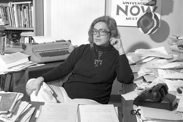 A woman sits at a desk