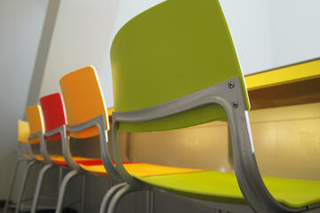 Close up shot of a line of chairs.