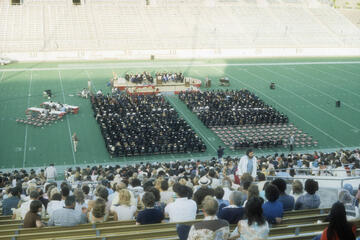 Graduates are seated on the field of Las Vegas Stadium