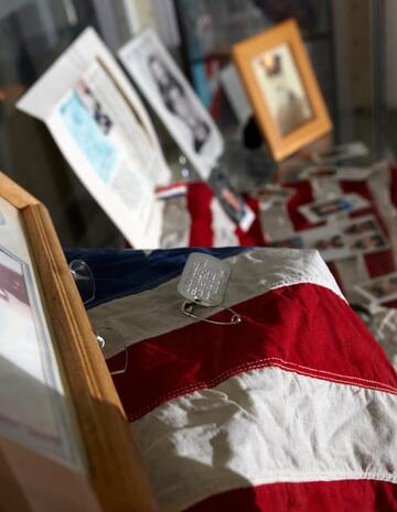Display cases at Lied Library complement the "Common Threads" installation with materials in the Sept. 11 memorial archive.