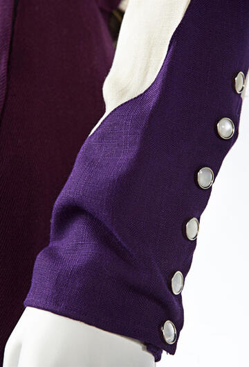 Close up view of the buttons on the end of a western styled shirt.