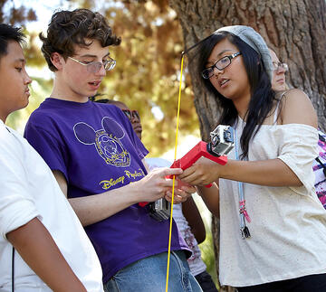 Students working with a video recording device.