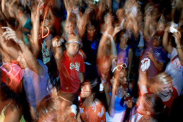 Blurred aerial view of students dancing at night.