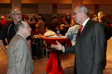 Neal Smatresk with employees at holiday reception.