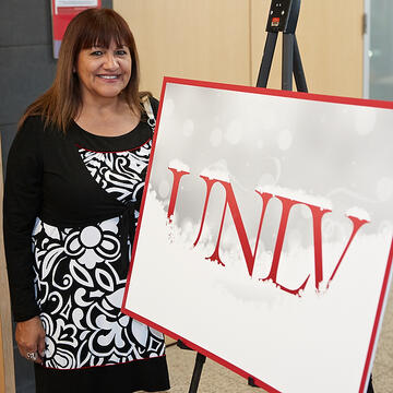 UNLV employee posing at holiday reception.