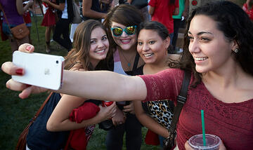 Four young woman taking a picture together.