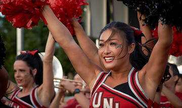 Front side view of a UNLV cheerleader in mid-cheer.