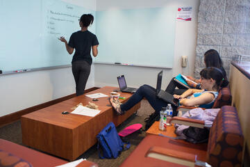 Students studying in a study room at the library.