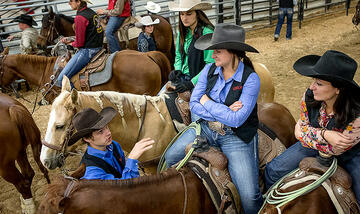 Female rodeo riders sitting on their horses during a rodeo event.