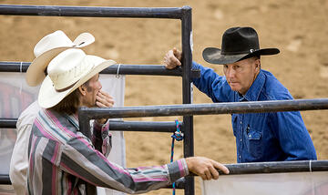 Competitors meeting during a rodeo competition.