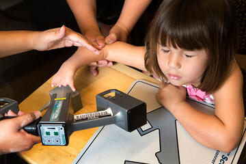 4-year-old, Hailey Dawson, getting her hand measured.