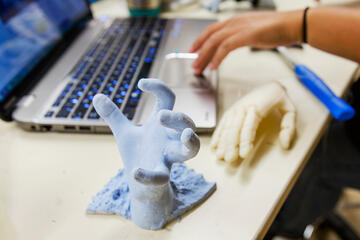 A clay model of a hand on a table