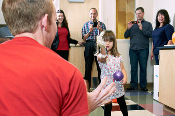 At Hailey's final fitting in October, she practices throwing a ball.