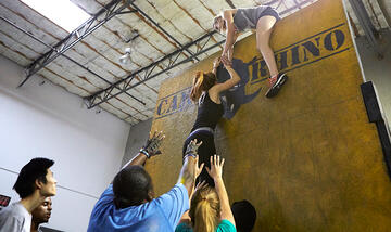 The Honors College team takes over the Camp Rhino fitness facility during a training session.