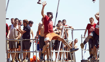Naweed Yusufzai rings the bell at the King of the Swingers obstacle.