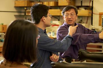 Yusheng Zhao confers with  laboratory team members Jinlong Zhu, a research  associate, and Shuai Li, a postdoctoral fellow.
