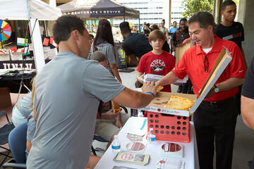 Of the nearly 1,800 students packing the residence halls, nearly 1,300 are freshman. Perhaps&nbsp;President Len Jessup's son, David (center), will be one of them in a few years.&nbsp;(R. Marsh Starks/UNLV Photo Services)