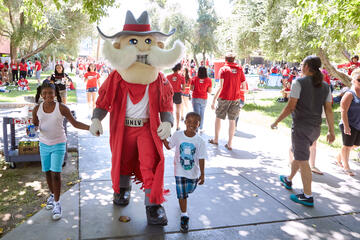 A couple future Rebels lead Hey Reb!&nbsp;back to their mother for some photos during the&nbsp;President's Barbecue. (Aaron Mayes/UNLV Photo Services)