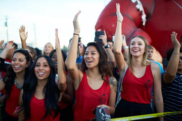 Female students raising their hands at the Premier event.