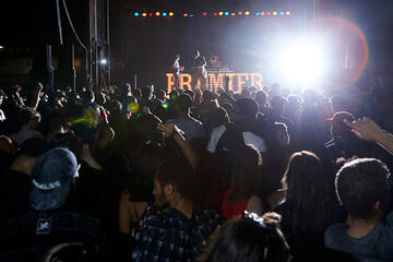 Students celebrate at night during the Premier event.