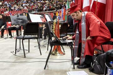 Doing double duty as a performer at the ceremony and a graduate.