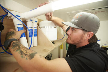 Jeremy Sandoval checks the water purification system