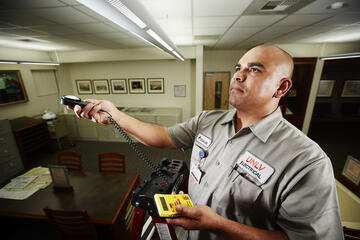 Armando Campos uses a light meter to check light levels