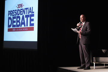Jacob Thompson speaks to attendees of the vice-presidential debate watch party