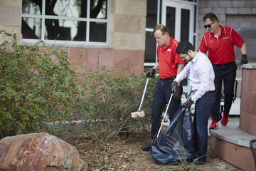 From left, Chief of Staff Fred Tredup, Special Assistant to the Chief of Staff Joseph Dagher and President Len Jessup clean up the bushes outside William S. Boyd Hall.&nbsp;(Josh Hawkins/UNLV Creative Services)