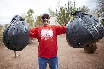 Dennis Mann of the McCarthy Building Company, which is constructing Hospitality Hall, future home of William F. Harrah College of Hotel Administration, hoists bags of leaves.&nbsp;(Josh Hawkins/UNLV Creative Services)