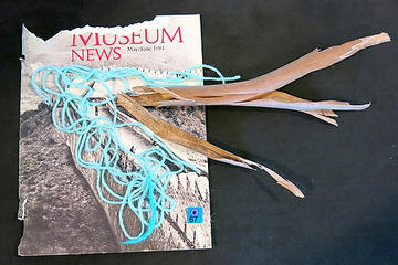 Travel collage by Deanne Sole containing a 1981 museum book cover, yarn, and bark from a plant.