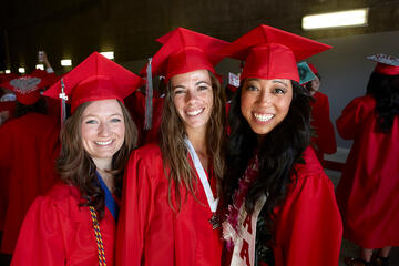 Female students in caps and gown during commencement.