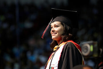 Female student smiling during commencement.