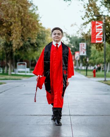 Jack Rico wearing UNLV cap and gown