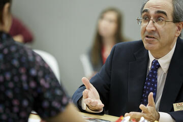 Political science professor John Tuman is interviewed inside the on-campus media green room as part of a pop-up event for visiting media during debate week.