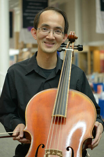 A man holding a cello