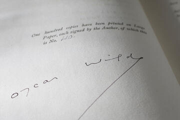 A page in a rare book shows Oscar Wilde's signature