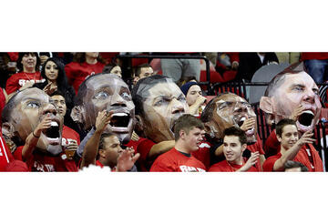 Student crowd holding up fathead cutouts of UNLV basketball players.