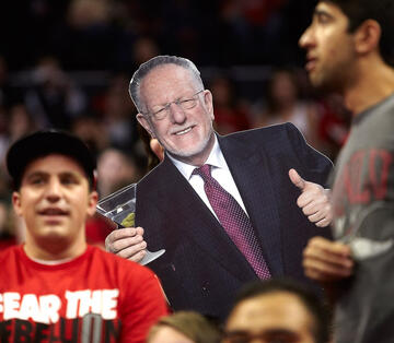 Student holds out fathead cutout of Mayor Oscar Goodman.