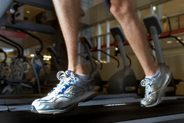Close up of person using treadmill.