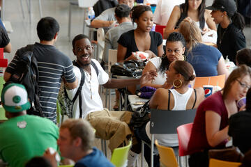 Students gathering around inside the Student Union.