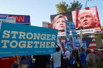 Supporters at the Presidential Debate holding up signs.