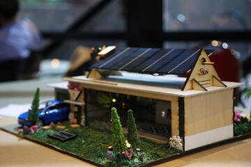 A small model house with solar panels