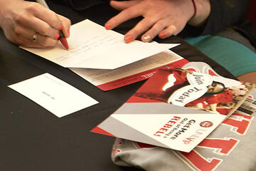 A student writing a thank you card.