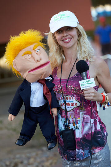 A reporter posing with a Donald Trump ventriloquist dummy.
