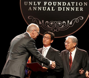 Greg Lee and his father, Theodore Lee, receive a Palladium Diamond citation from President Smatresk. The Lee family’s generosity includes a gift that transformed the College of Business, now the Lee Business School. (Geri Kodey/UNLV Photo Services)